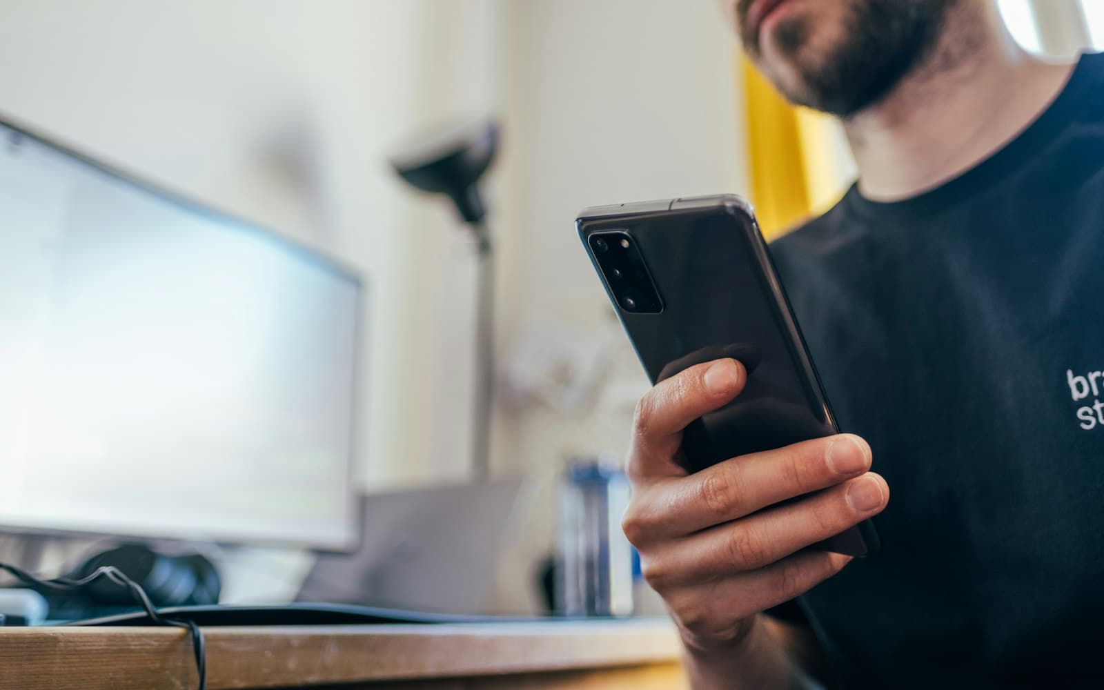 Tradesman checking enquiries on his phone
