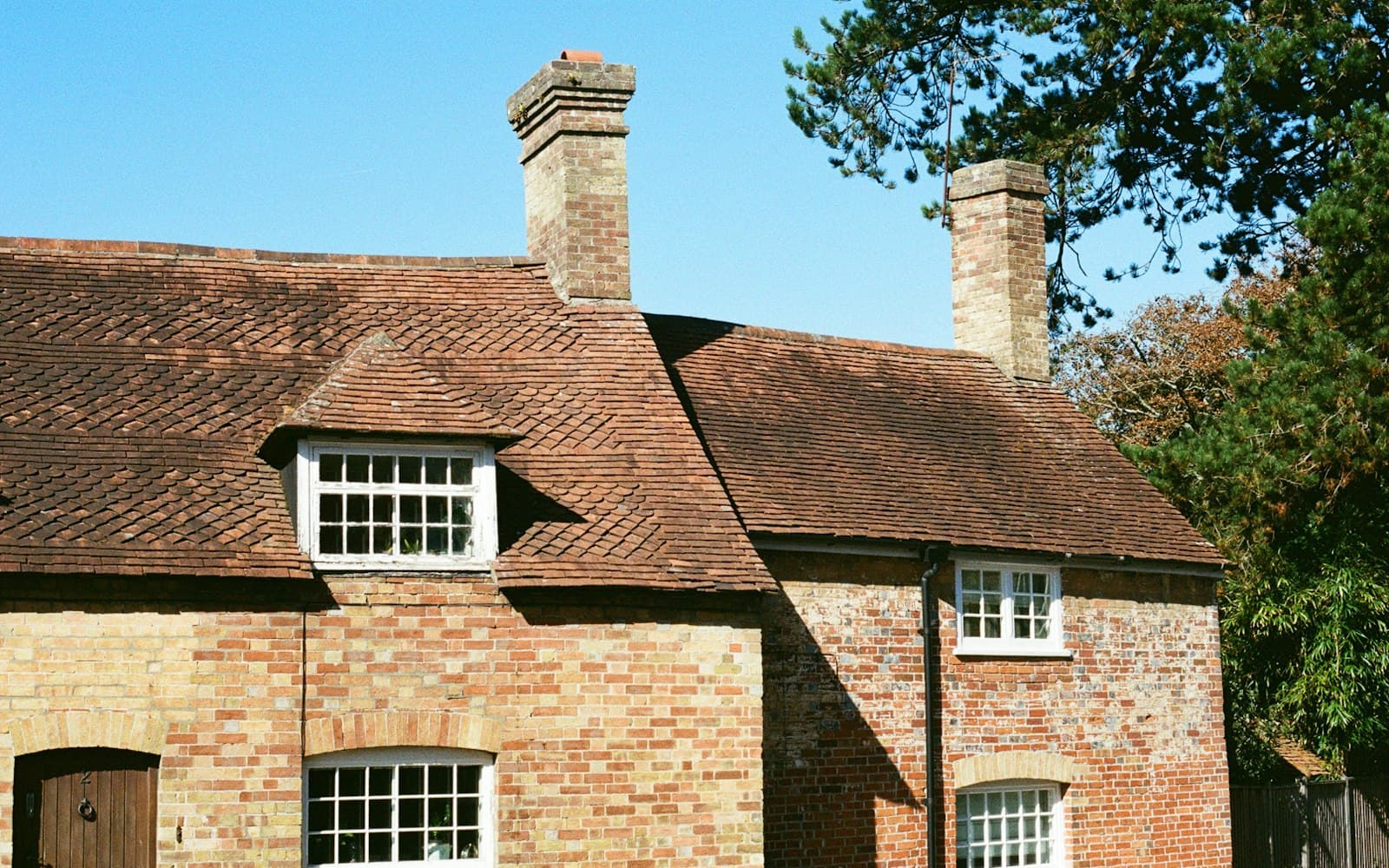 Brick house with a tiled roof and dormer windows