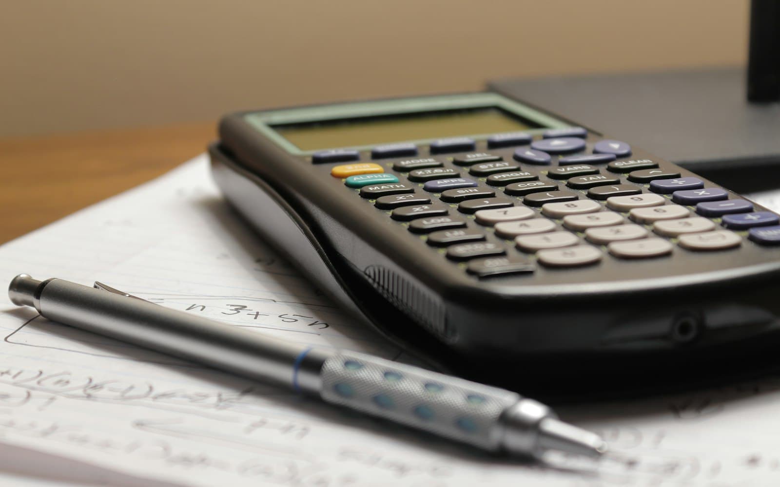 Calculator and pen on a costings sheet