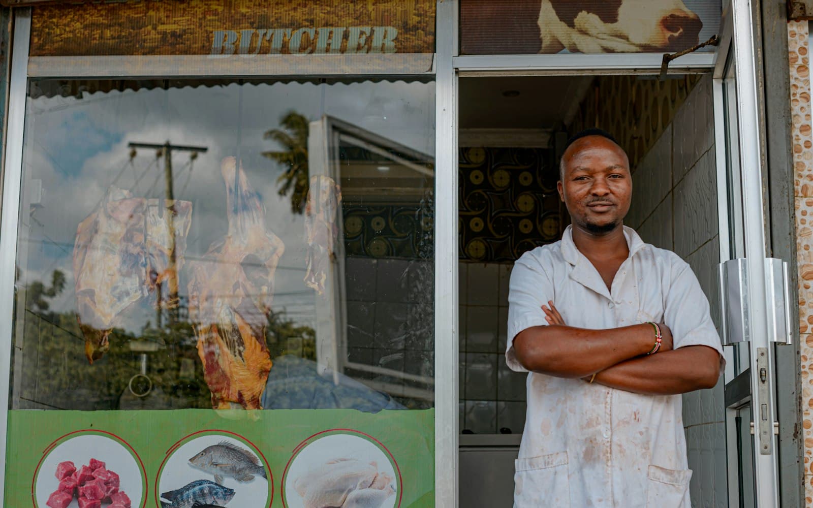 Small business owner standing outside his shop