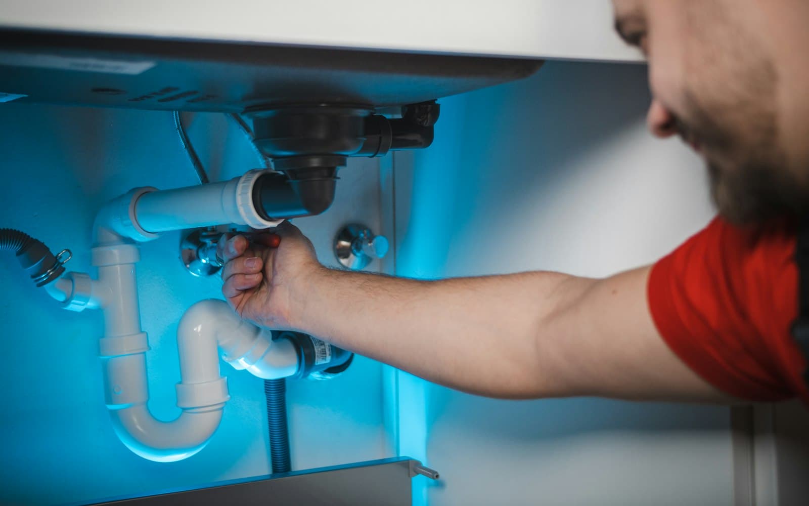 Plumber fitting pipework in a wall