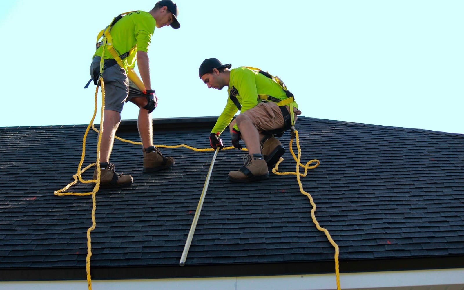 Two roofers working on a pitched roof