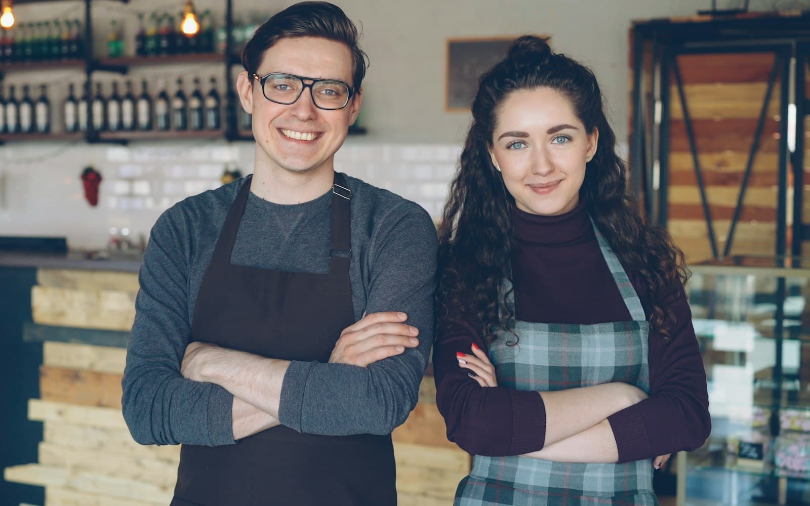 Two local business owners standing proudly in their cafe
